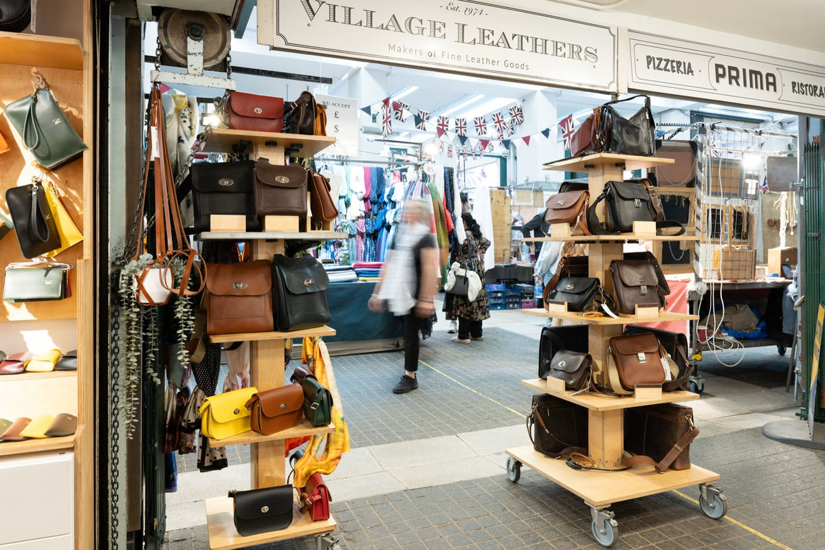 Village Leathers shopfront in Covent Garden's Jubilee Market, with bags on display